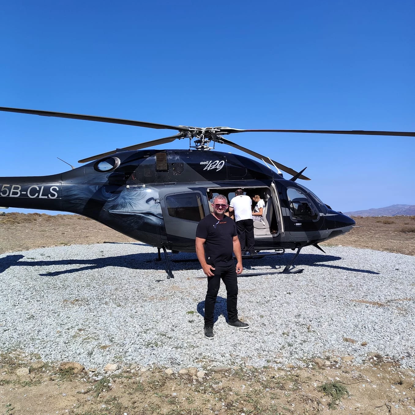 VIP escort beside private helicopter